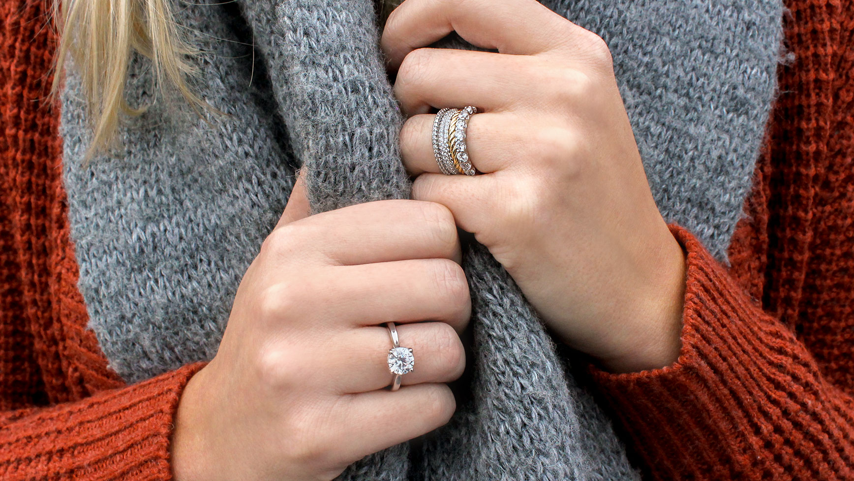 A women wearing a Diamond Nexus engagement ring on one hand and a mixed-metal band stack on her other