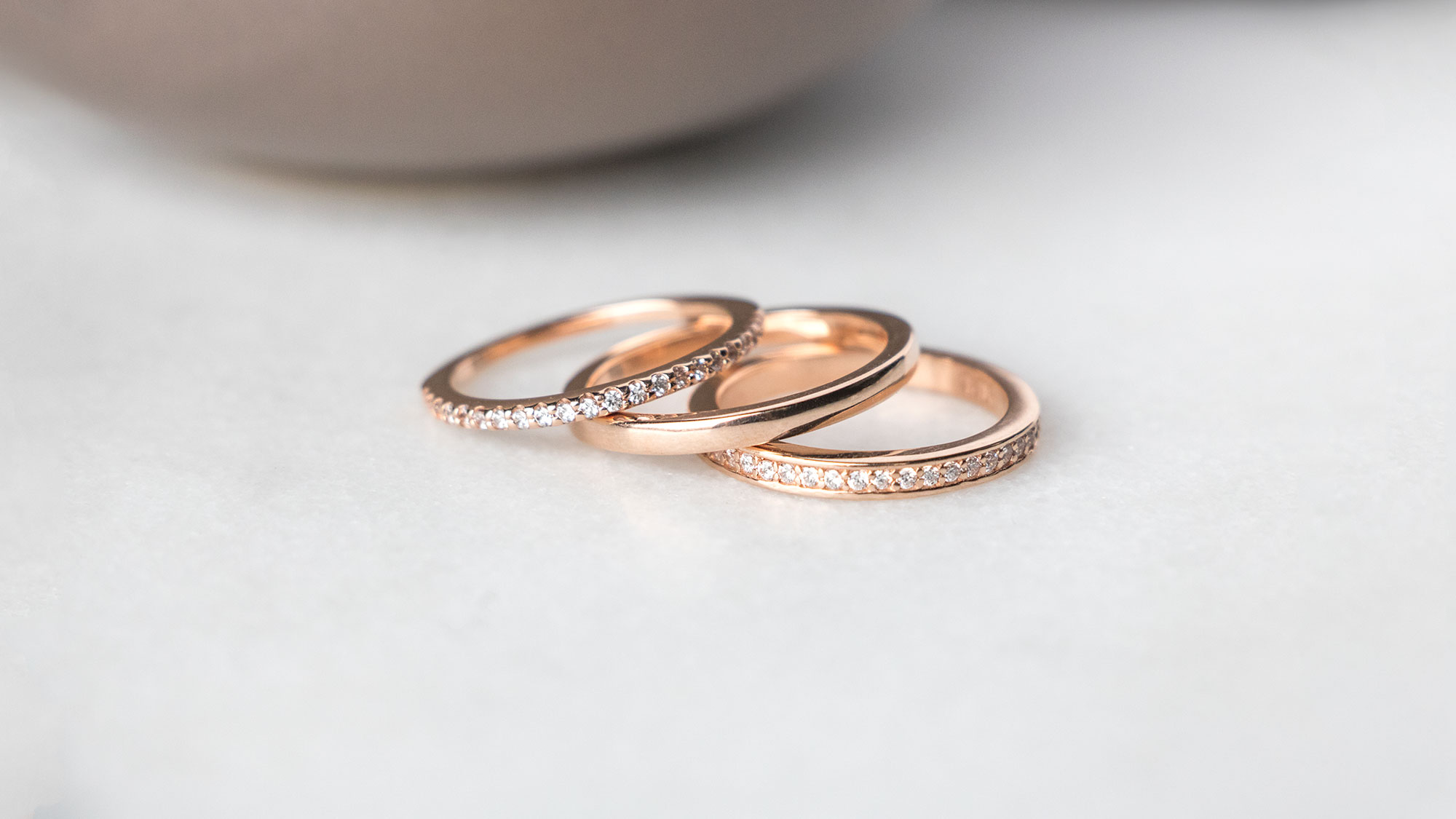 A rose gold ring stack featuring three Diamond Nexus bands