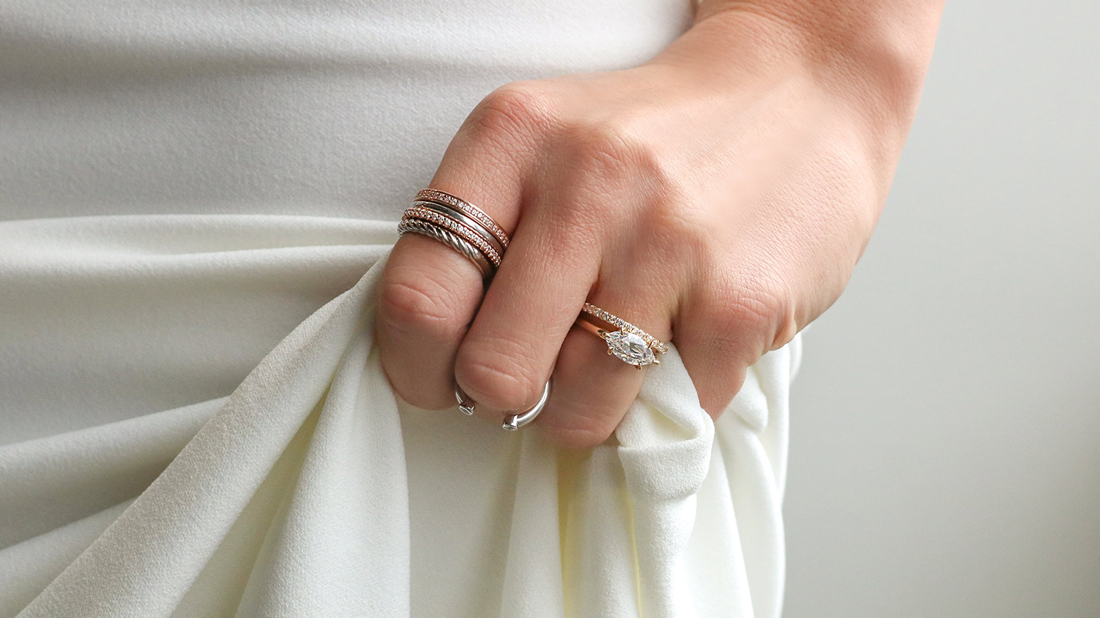 A bride wearing a mixed-metal ring stack from Diamond Nexus