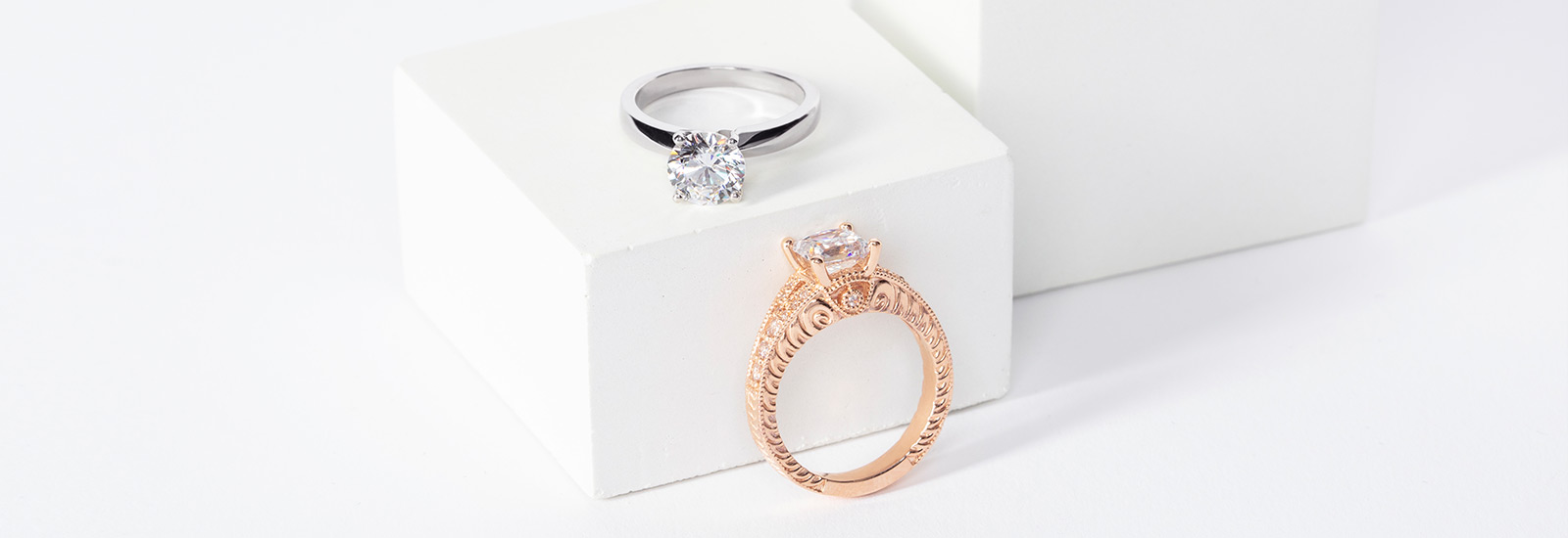 two white and rose gold engagement rings