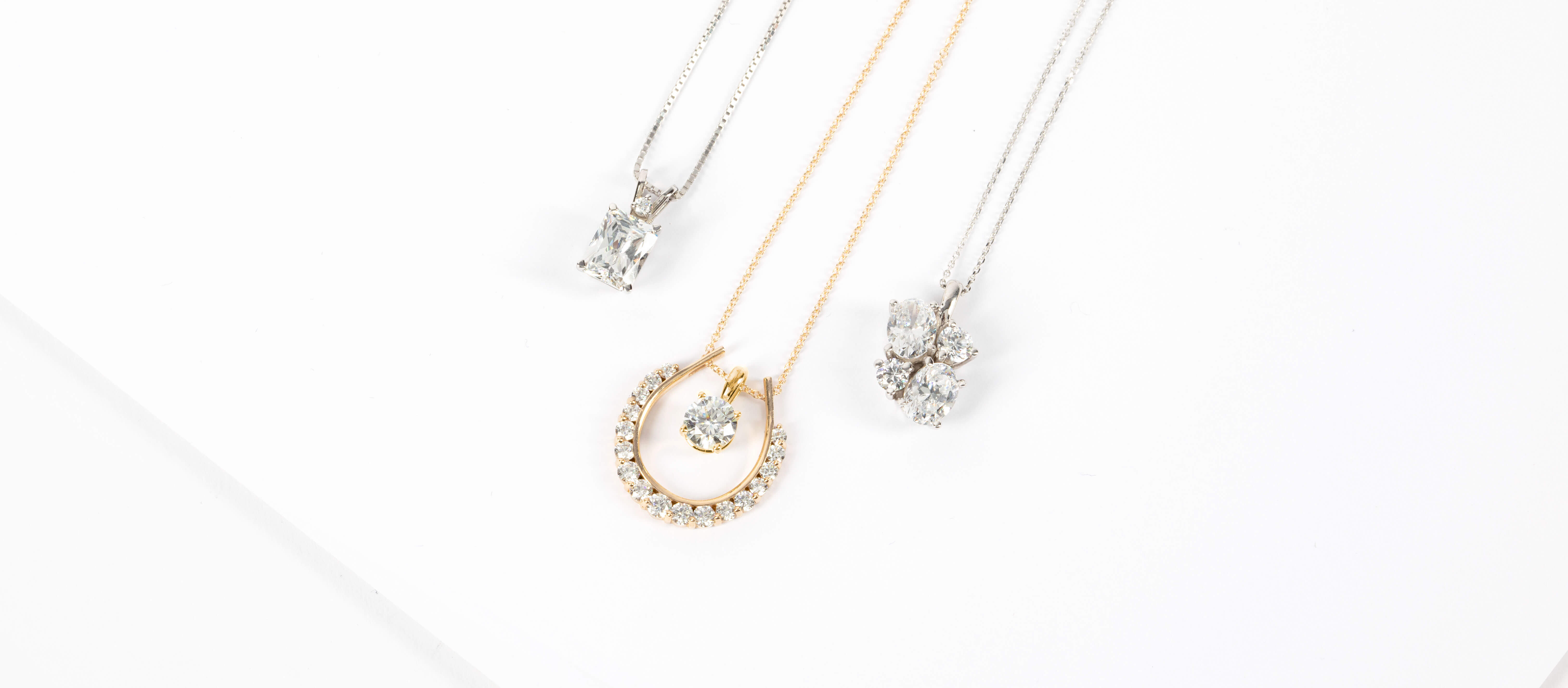 Assorted Diamond Nexus necklaces in white and yellow gold