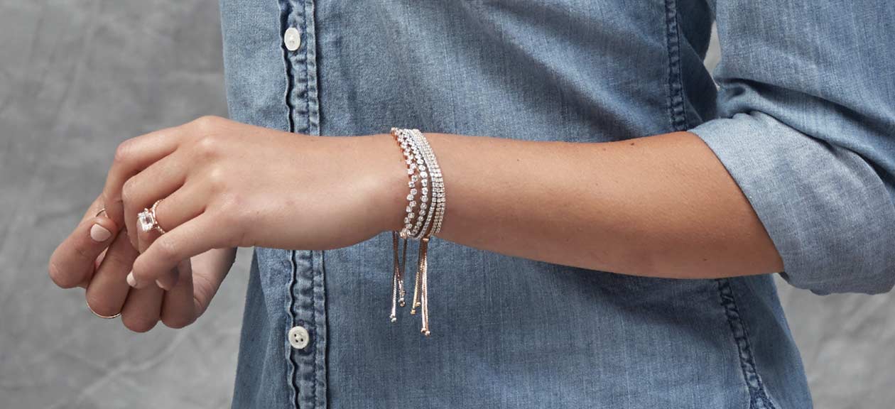 stacked bracelets and rings on a woman