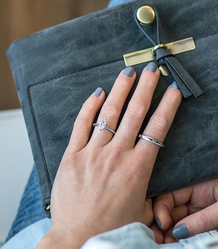 woman's hand with a few rings on