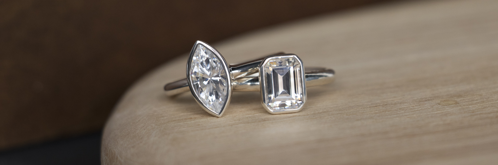 Two bezel set lab created diamond simulant engagement rings