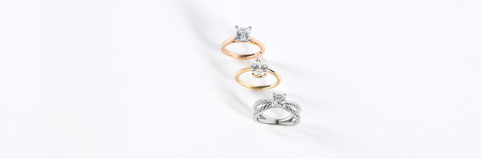 three engagement rings side by side