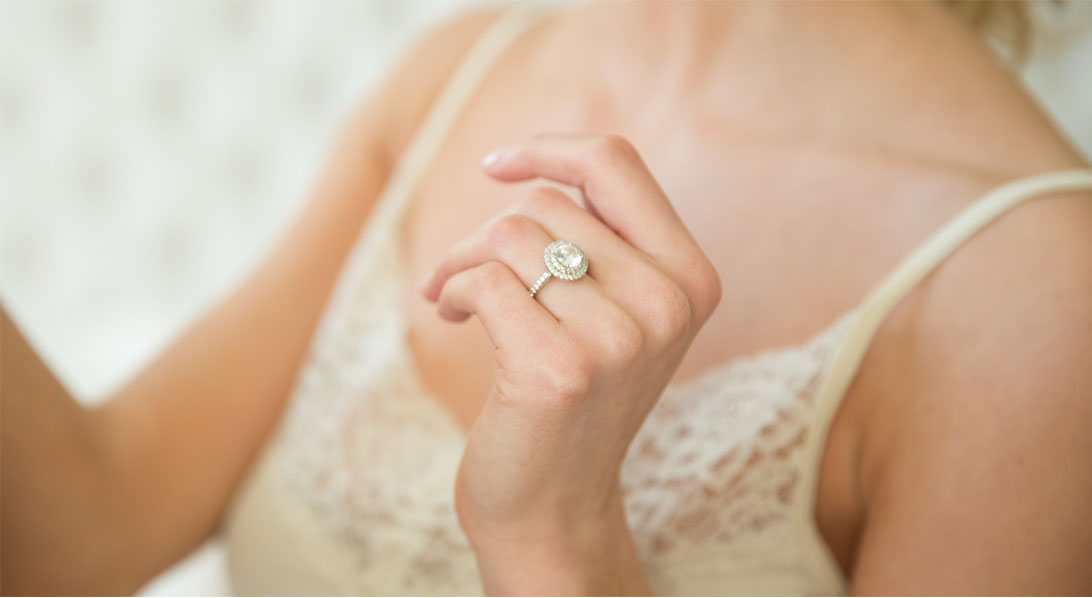 halo engagement ring on a hand