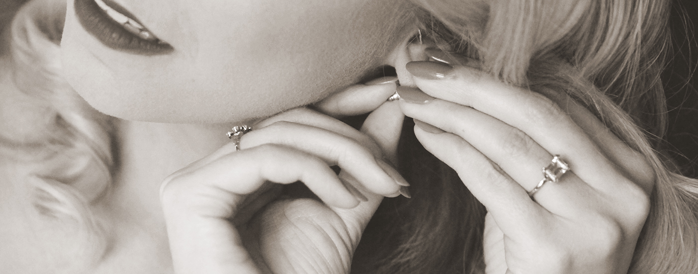 woman putting earrings on