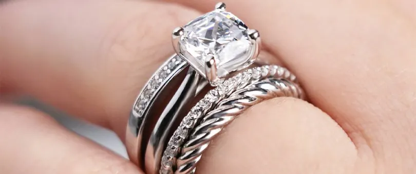 engagement ring and wedding bands stacked