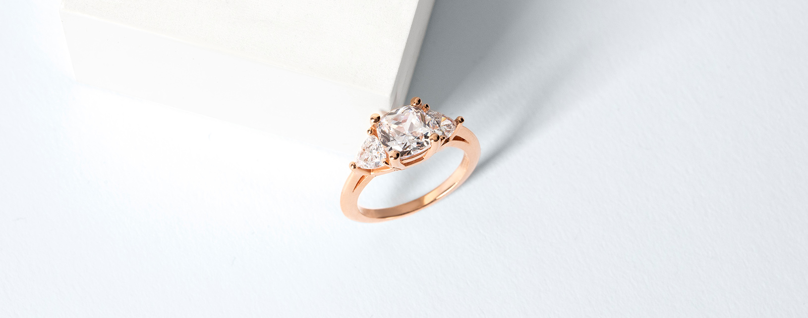 A classic three stone setting with a princess cut diamond alternative center stone