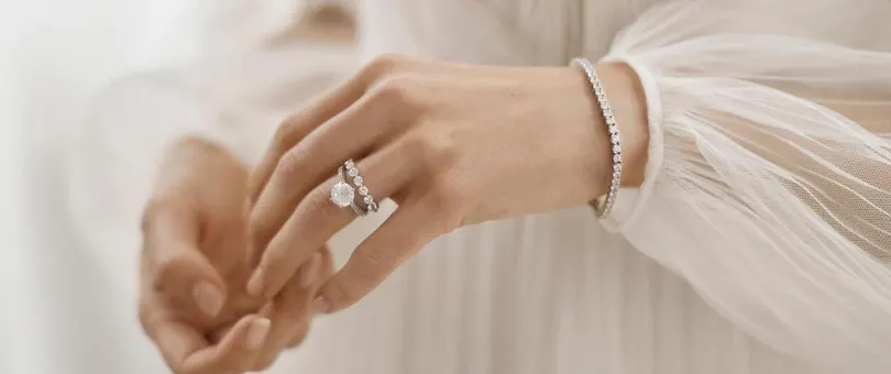 wedding and engagement rings stacked on a left hand