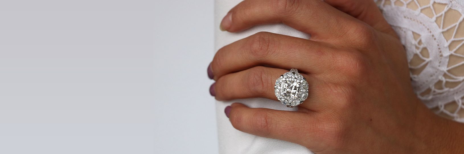 A white gold ring featuring several colorless stones